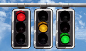 Three Traffic Lights Against Blue Sky Background Three traffic lights against blue sky background